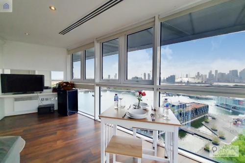 a large living room with a view of a city at London ExCeL Stays in London