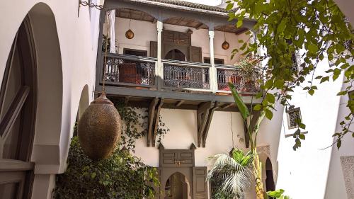 a building with a balcony on the side of it at Riad Jardin Des Sens & Spa in Marrakech