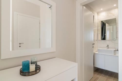 a white bathroom with a sink and a mirror at Valentino Luxury Villa in Plános