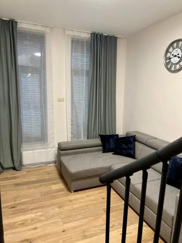 a living room with a couch and a table at Exclusive two-level apartment with private terrace on the canal Brussels in Brussels