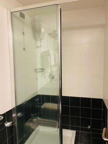 a shower with a glass door in a bathroom at Locanda del Glicine in Campagnatico