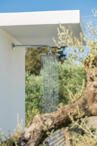 a bird feeder hanging from a building at Valentino Luxury Villa in Plános