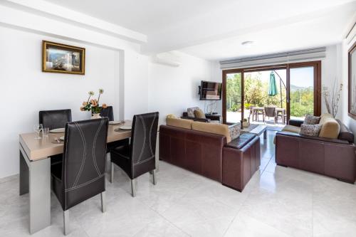 a living room with a table and a couch at Bellapais Apartments in Kérynia