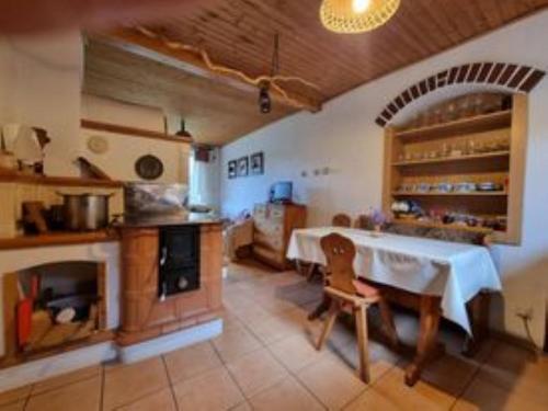 a large kitchen with a table and an oven at Chata Anna in Nižné Hágy