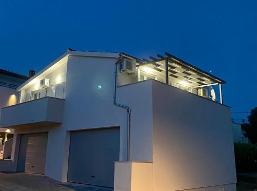 a white house with lights on top of it at Villa Adria in Vodice