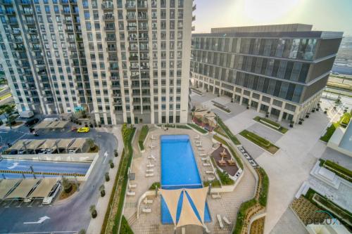 an aerial view of a large building with a pool at Graceful 1BR at Park Heights Dubai Hills MBR City by Deluxe Holiday Homes in Dubai