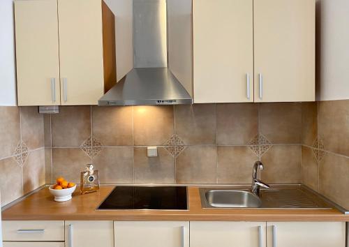 a kitchen with white cabinets and a sink at Villa Adria in Vodice