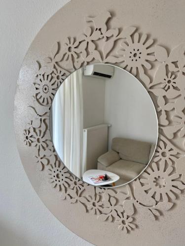 a mirror on a wall with a chair in a room at Villa Adria in Vodice