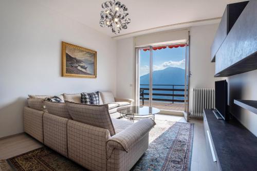 a living room with a couch and a table at Wohnung mit grandiosem Ausblick in Tremosine Sul Garda