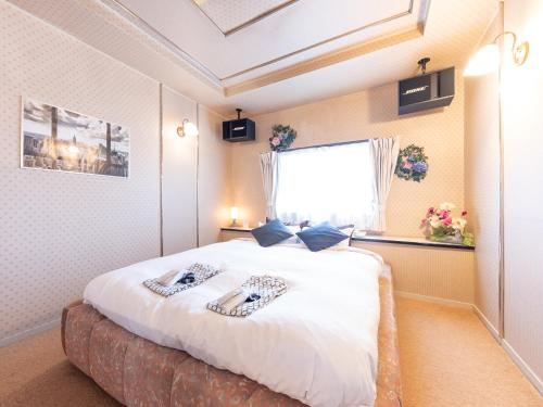 Postel nebo postele na pokoji v ubytování Tabist Hotel Nizi Fuefuki Misaka