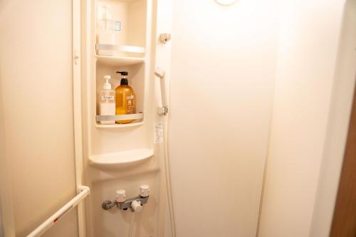 a refrigerator with a bottle of alcohol in it at TSUDOI guest house in Unzen