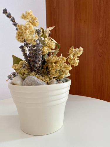 a white vase with flowers in it on a table at Villa Adria in Vodice