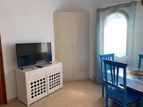 a living room with a tv and a table and chairs at La Vista Bonita in Corralejo