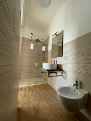 a bathroom with a sink and a toilet and a mirror at Guest House Bellavista Nebida in Nebida