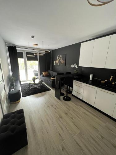 a large living room with a table and a living room at Black Amber in Władysławowo