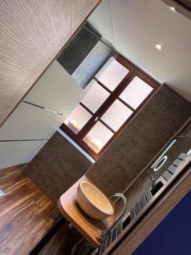 a kitchen with a wooden counter top with a window at Logis Hôtel de france in La Côte-Saint-André