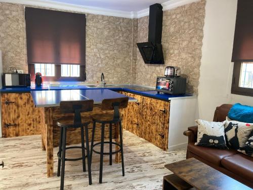 a kitchen with a large island in a room at La Casita in Ventas de Zafarraya