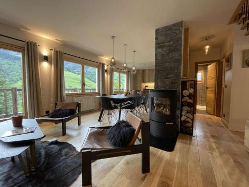 un salon avec une cheminée et une table dans l'établissement Chalet contemporain 8 pers, 4 chambres, vue sur montagnes, parking, près village - FR-1-342-243, à Beaufort