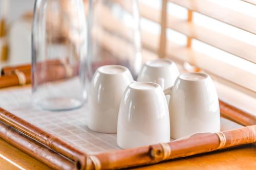 a group of white candles on a wooden table at 安平福巷人文家宿 Anping Hok Hāng in San-k'un-shen