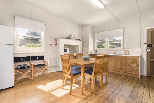 a kitchen with a table and chairs in it at Oak And Pine in Apollo Bay