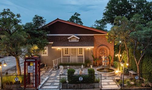 a house with a telephone booth in front of it at Tarnsiri Boutique Resort in Kanchanaburi City