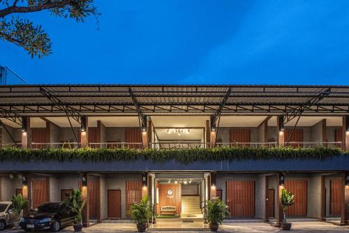 a building with a car parked in front of it at Tarnsiri Boutique Resort in Kanchanaburi City