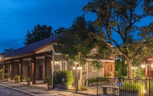 a house with a fence in front of it at Tarnsiri Boutique Resort in Kanchanaburi City