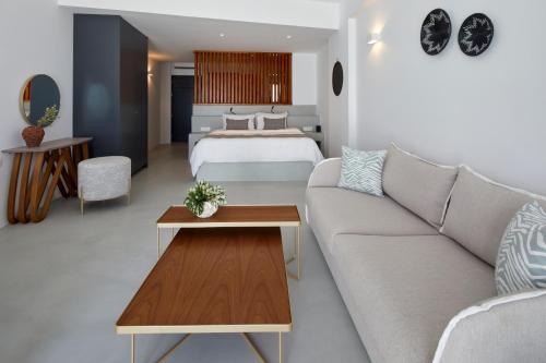 a living room with a couch and a bed at Santorini Princess Spa Hotel in Imerovigli
