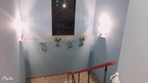 a blue wall with some plants on it at ホテルルネサンス土浦 in Tsuchiura