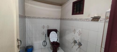 a bathroom with a toilet and a shower at Munnar happy holidayss in Munnar