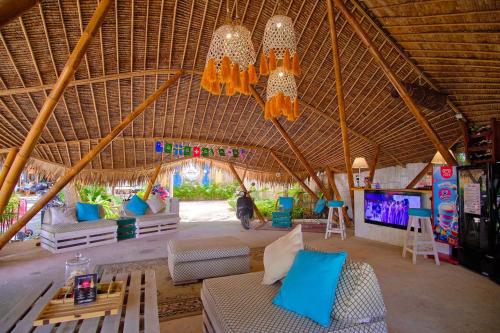 a living room with a couch and chairs and a tv at Beach House Camp in Na Jomtien