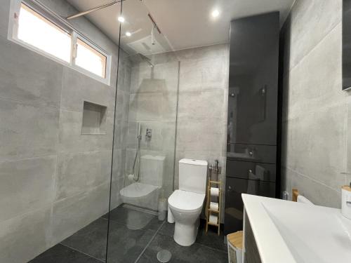 a bathroom with a toilet and a shower and a sink at Rose House By Atlantic Holiday in Machico