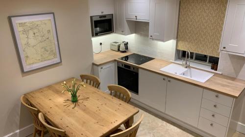 a kitchen with a wooden table and a wooden counter top at Oulton Park Lodge in Little Budworth