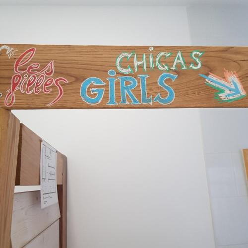 a sign that reads chicago girls on top of a door at El Hostel & CO in Santander