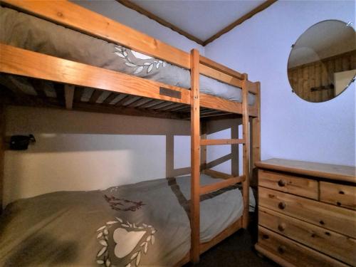 a bedroom with bunk beds with a mirror and a dresser at Charmant studio cabine 4 pers. aux Bruyères, pied des pistes, animaux permis - FR-1-452-7 in Les Menuires