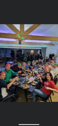 a group of people sitting at a long table eating at King Richard's Luxury Lodge - Sleeps up to 8, Dog Friendly, Near Sherwood Forest at Fairview Farm in Nottingham set in 88 acres and great for Groups, Family Gatherings & Corporate events in Nottingham