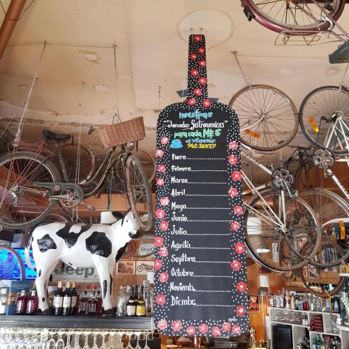 a sign in a store with a cow and bikes at El Hostel & CO in Santander