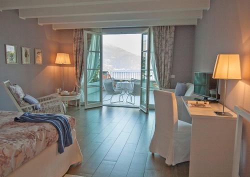a hotel room with a bed and a desk and a room at Borgo Le Terrazze in Bellagio