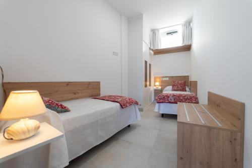 Postel nebo postele na pokoji v ubytování Apartamentos turísticos De La Abuela Carmen