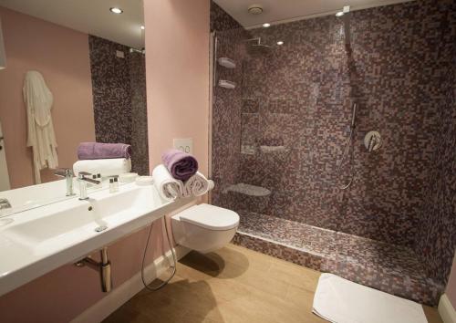 a bathroom with a sink toilet and a shower at Borgo Le Terrazze in Bellagio