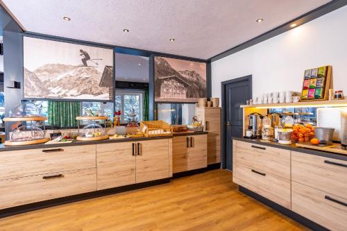 a kitchen with wooden cabinets and food on display at Haus Garni Luggi Leitner in Mittelberg