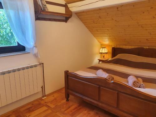 a bedroom with a bed with two towels on it at Holiday Home Modruš in Modruš