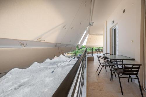 a room with tables and chairs and a large painting on the wall at AMELIA HOUSE in Preveza