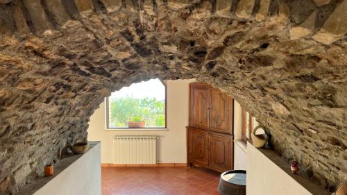 a room with a stone wall and a window at Antico Casale da Gemma - Fuscaldoapartment in Fuscaldo