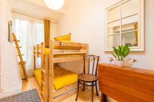 a bedroom with two bunk beds and a desk at The Artists Workshop - Norfolk Holiday Properties in Norwich