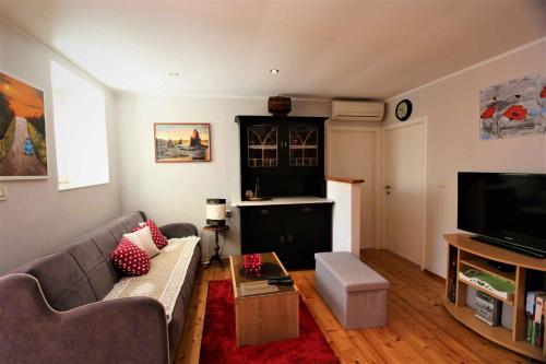 a living room with a couch and a tv at Apartment in Klimno/Insel Krk 12467 in Klimno
