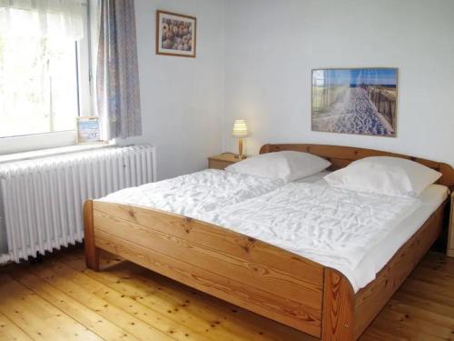 Postel nebo postele na pokoji v ubytování Ferienwohnung Alte Grundschule Berdum 2