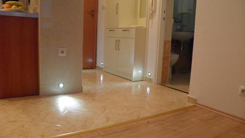 a kitchen with a tile floor and a mirror at Apartment 28 in Split