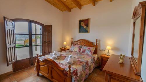 a bedroom with a bed and a large window at Casa El Mirador de Isabel Vélez-Málaga by Ruralidays in Vélez-Málaga