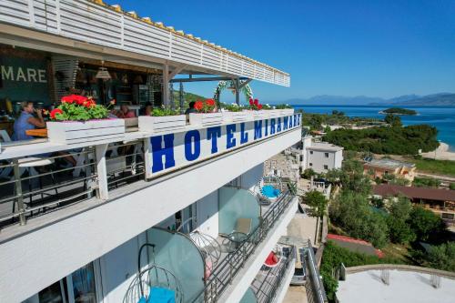 a hotel with flowers on the balcony of a building at Hotel Mira Mare in Ksamil